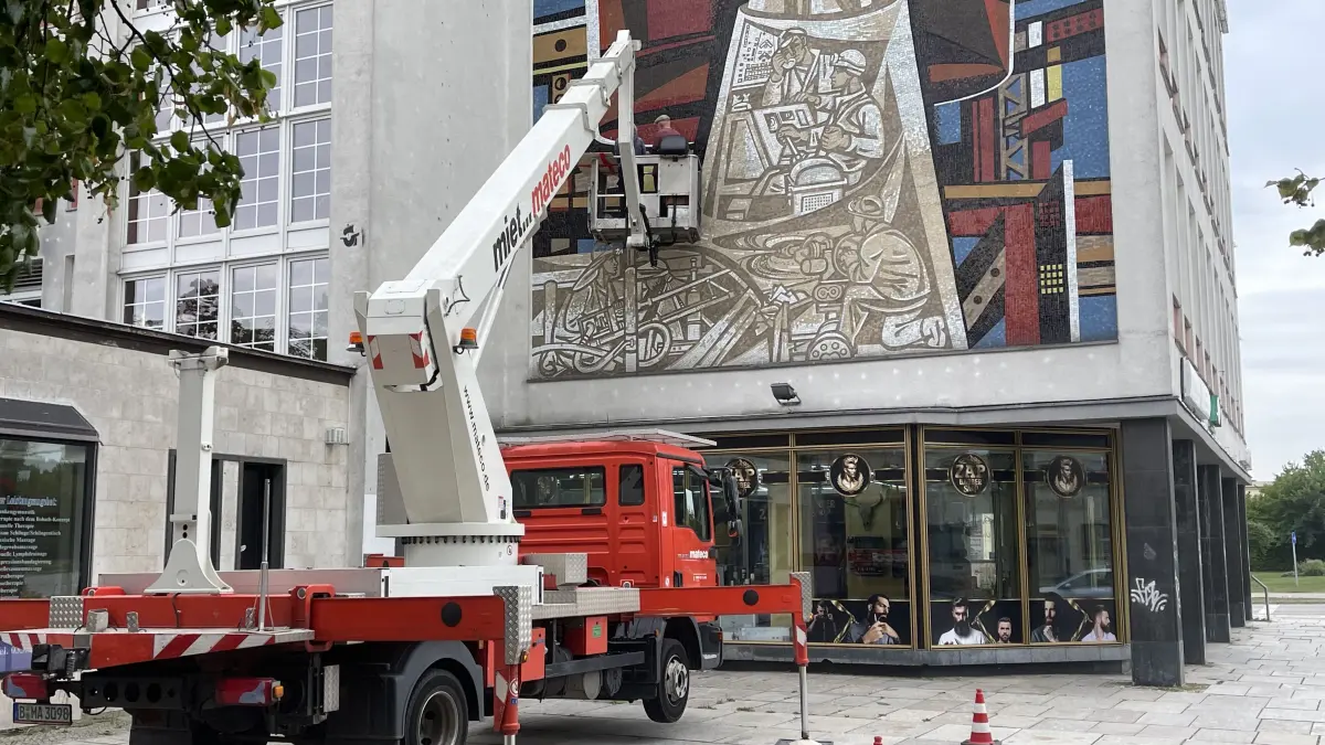 Mit Hilfe einer Hubbühne wird das Wandmosaik von Walter Womacka in der Lindenallee in Eisenhüttenstadt untersucht.