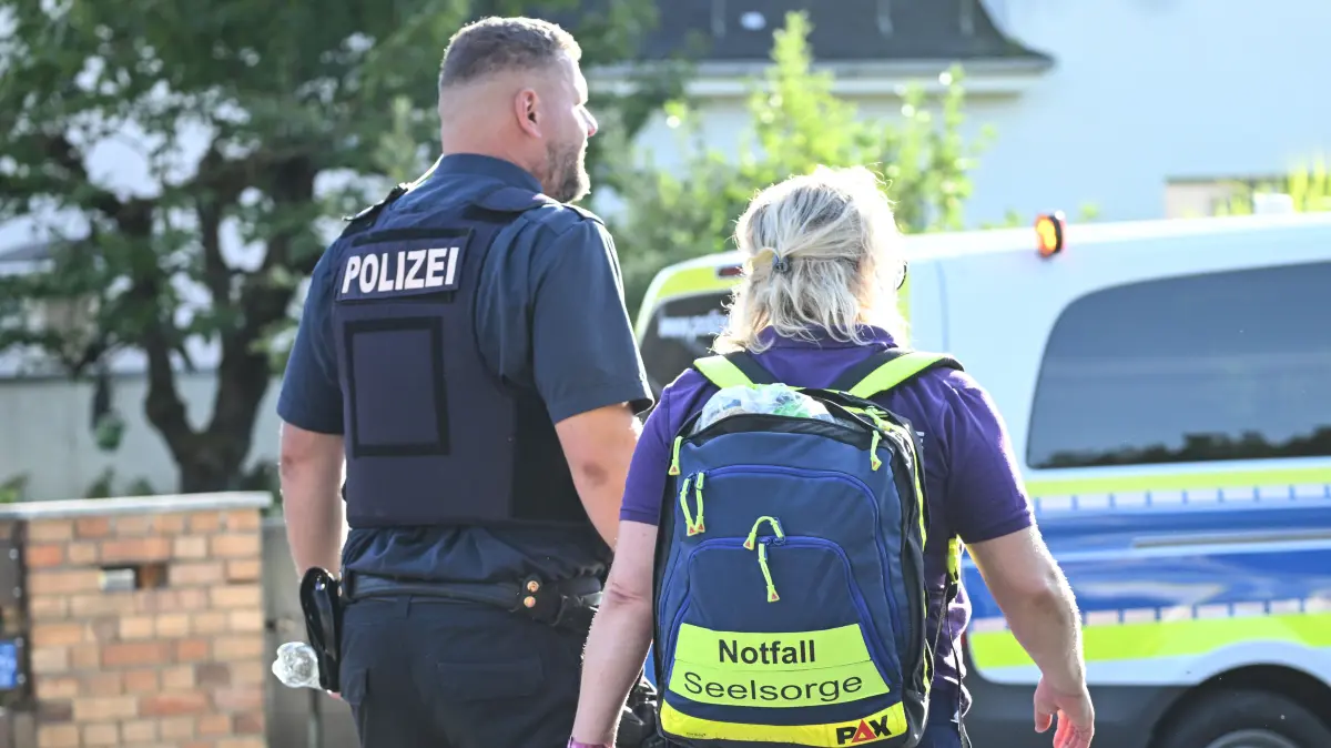 Mitarbeiter der Notfallseelsorge und Polizisten am Einsatzort nach einer Gewalttat in Gosen-Neu Zittau. Der Verdächtige schweigt weiter.