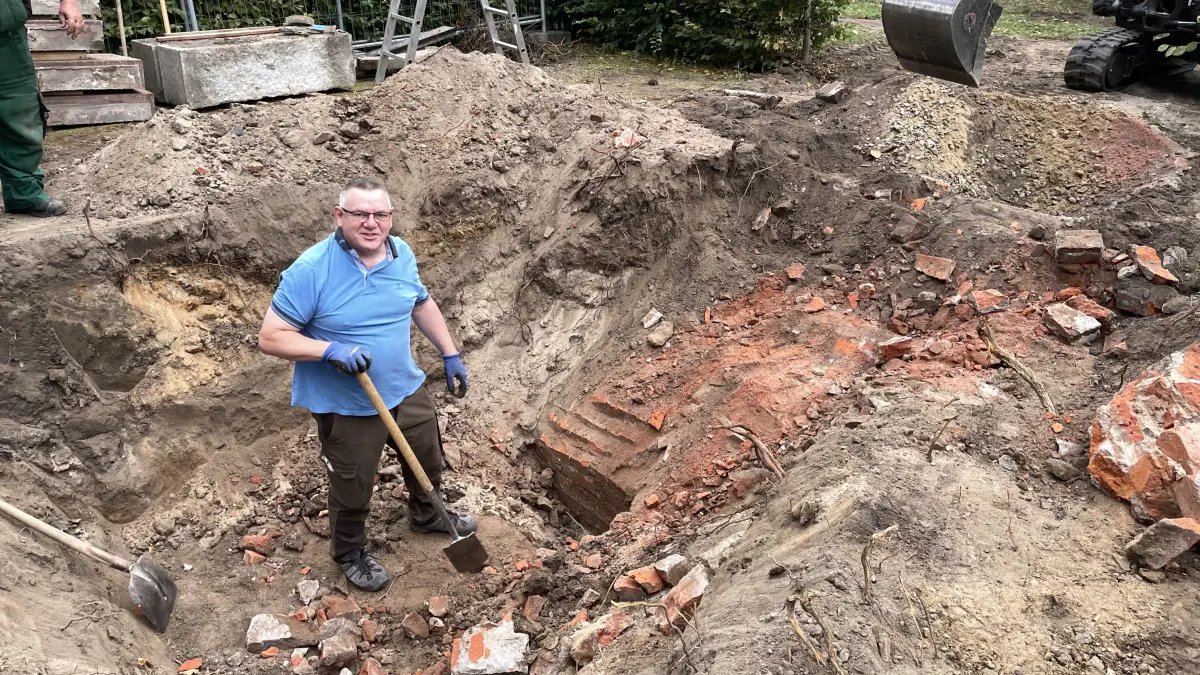 Auf der Suche nach dem Grundstein in Letschin: Bürgermeister Michael Böttcher hat selbst zum Spaten gegriffen.
