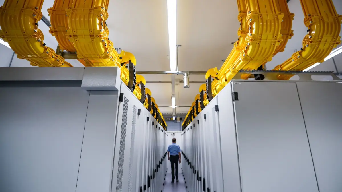 Rechenzentrum: ARCHIV - 13.10.2022, Sachsen, Taucha: Ein Mitarbeiter überprüft Serverschränke im Rechenzentrum im Datacenter Leipzig. Am gleichen Tag ging hier der erste regionale Internetknoten für die Bundesländer Brandenburg, Sachsen, Sachsen-Anhalt und Thüringen ans Netz. In Deutschland werden immer mehr Rechenzentren in Betrieb genommen - mit dem Wachstum in Ländern wie USA und China kann die Branche aber nicht ganz mithalten. (zu dpa: «Grüne und Umweltverbände sehen Risiken in Rechenzentren») Foto: Jan Woitas/Deutsche Presse-Agentur GmbH/dpa +++ dpa-Bildfunk +++
