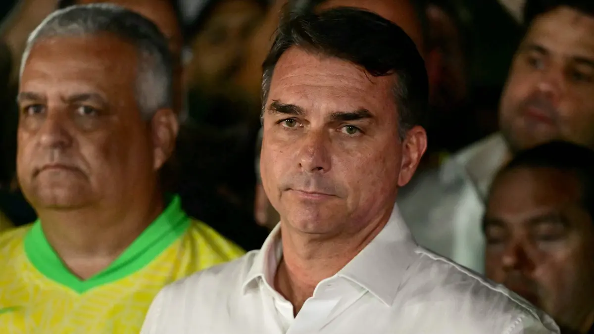BRAZIL-ELECTION-RUNOFF-VOTE: Brazil's right-wing senator and presidential candidate for the Liberal Party (PL) Flavio Bolsonaro reacts after knowing the first results in the presidential runoff election, in Brasilia, on October 25, 2026. Brazil's President and re-election candidate for the Workers' Party (PT) Luiz Inacio Lula da Silva pulled off a dramatic comeback on October 25, 2026, as he clinched election victory against right-wing senator Flavio Bolsonaro, who trounced him in the first round. (Photo by Pablo PORCIUNCULA / AFP)